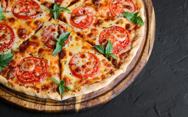a pizza with tomatoes and basil